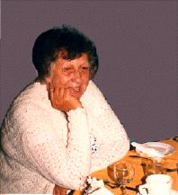 Lorna, seated at a table