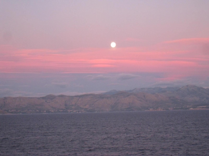 A full moon rising over Croatian mountains