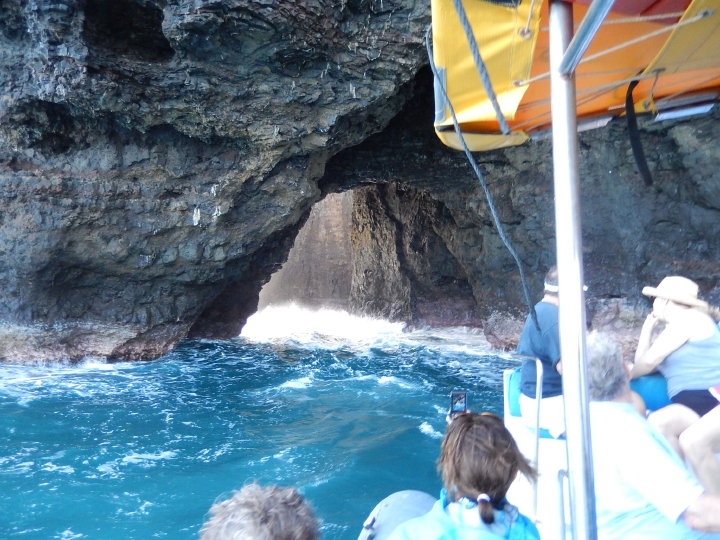 A hole in a cliffside through which a small boat could pass